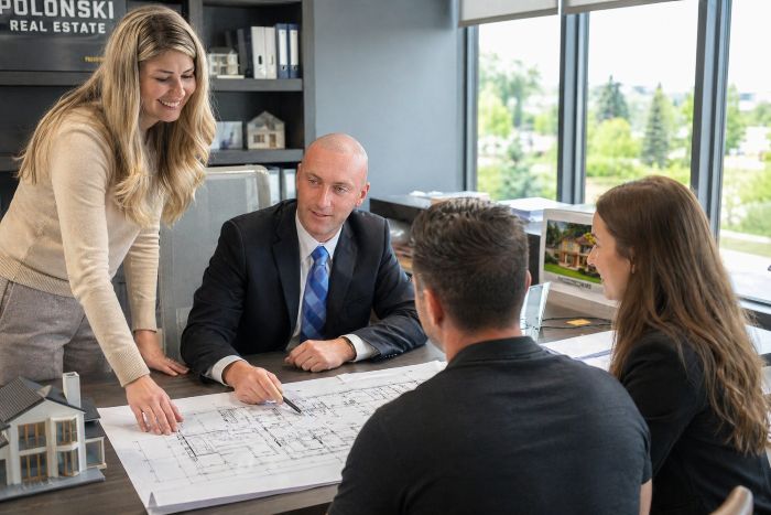 Jason Polonski, realtor in Kanata and Ottawa discussing with his team Condo vs Freehold