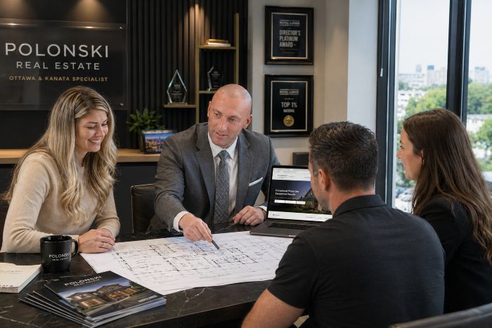 What Buyers Notice First When Viewing Your Home in Ottawa. Jason Polonski, real estate agent in Kanata and Ottawa, going over home plans with his clients